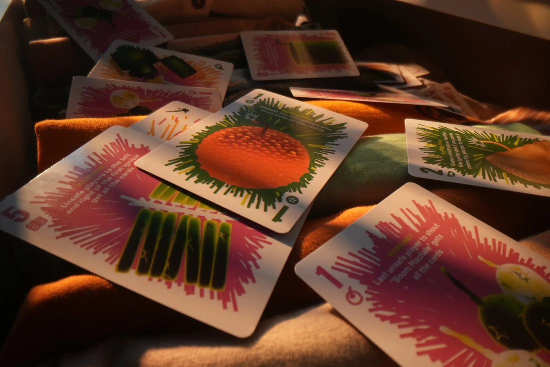 Boom Machale cards spread across fabric in warm afternoon sunlight