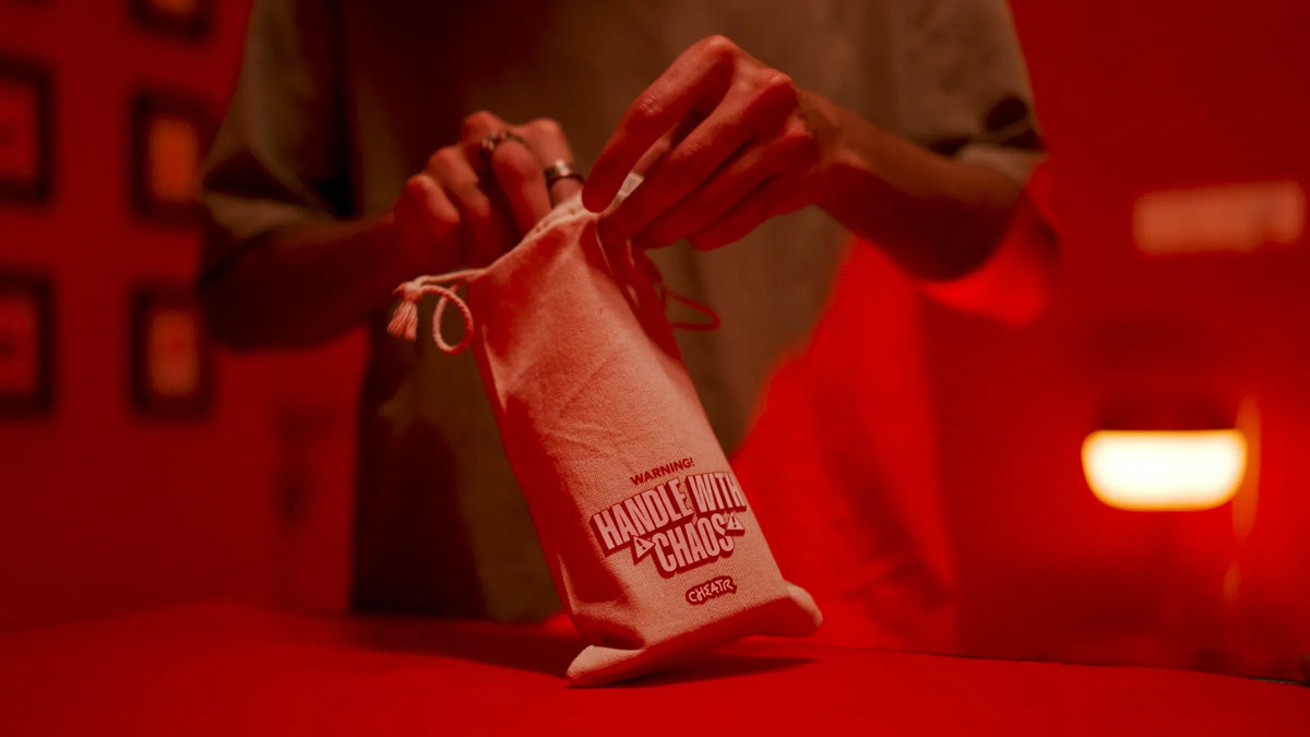 Close-up of the Cheatr Handle With Chaos game bag in a dramatic red scene