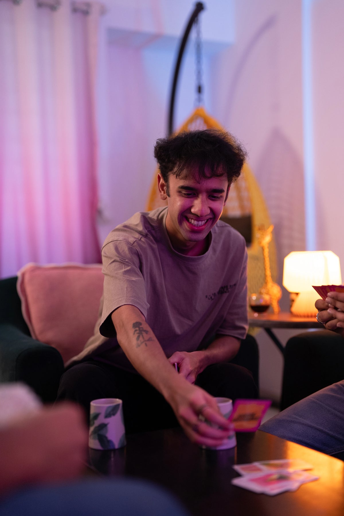 Friends playing Boom Machale card game at a house party