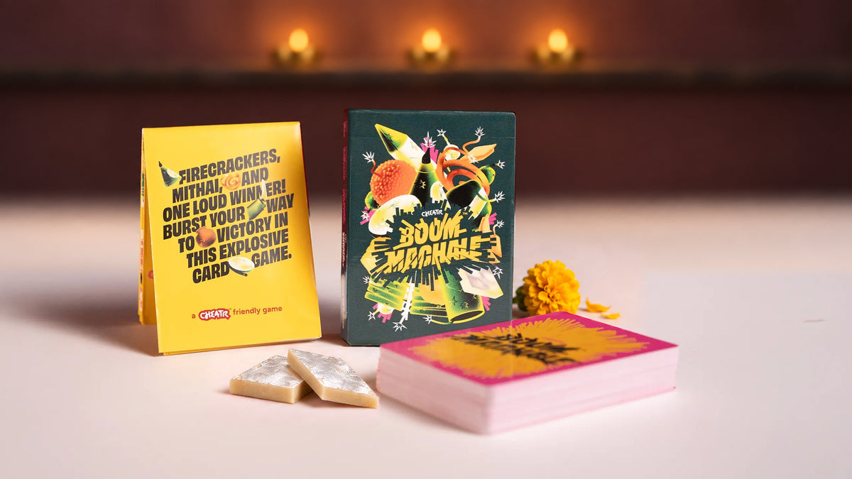 Boom Machale card game with kaju katli, yellow marigold and brass diyas